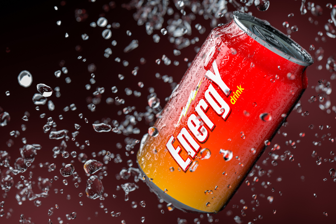 Red energy drink can surrounded by water drops, symbolizing hydration and kidney health risks.