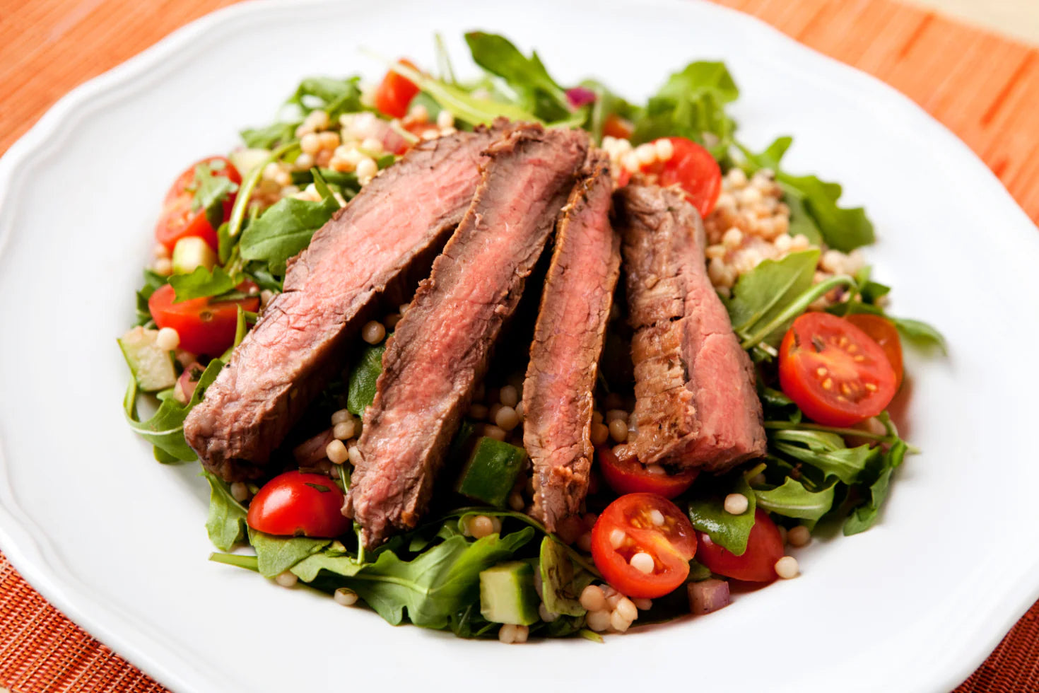 Plate of beef dish with vegetables.