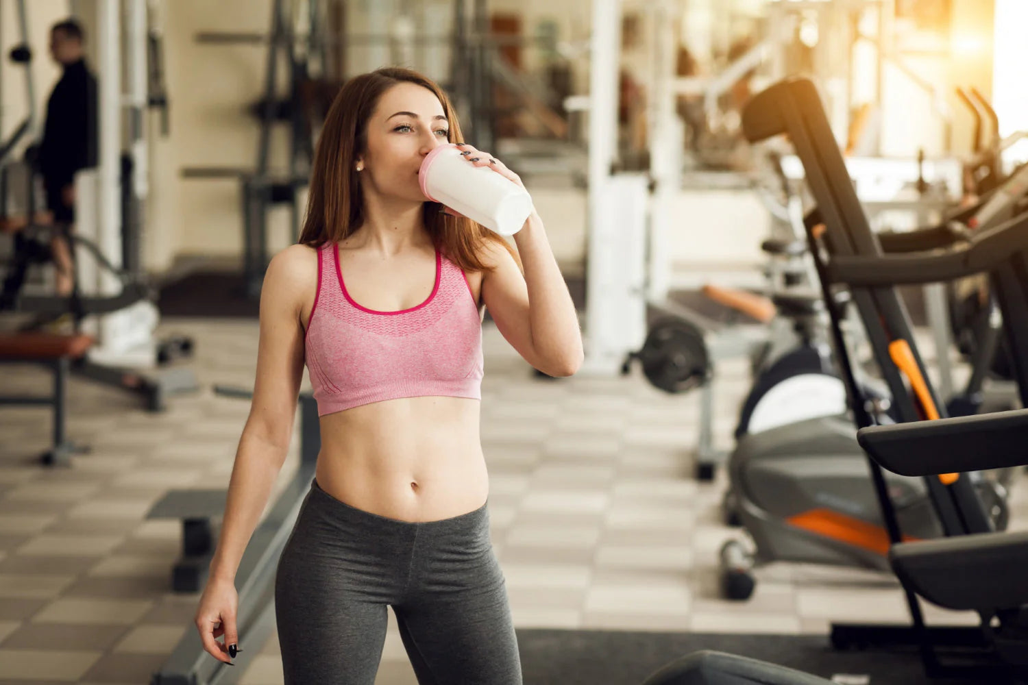 Woman drinking her protein shake.