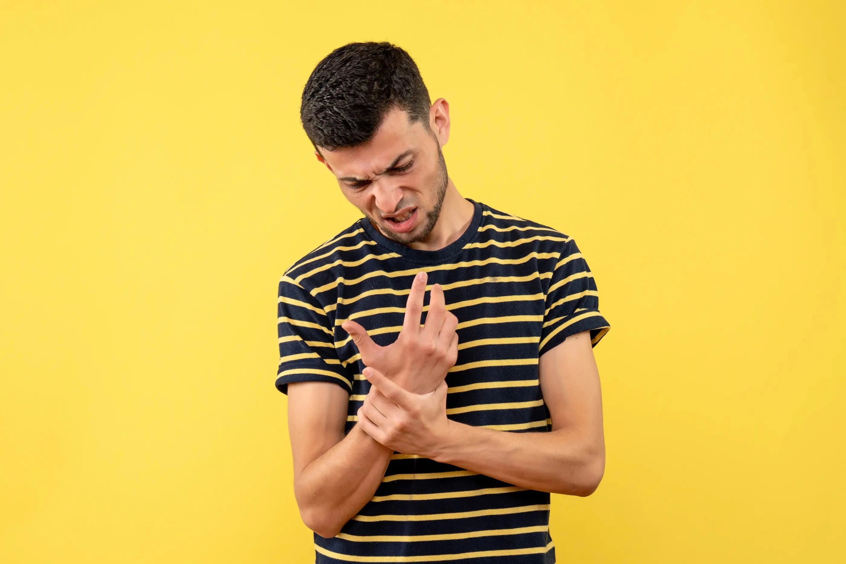 A man holding his hand due to bruising.