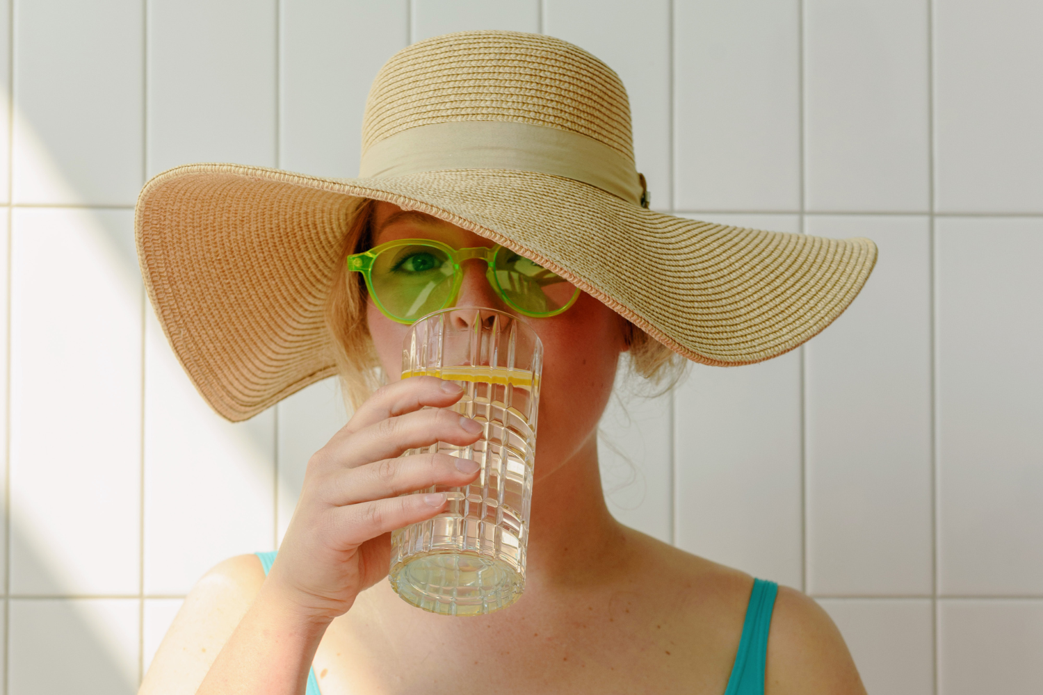 Woman drinking lemon water.