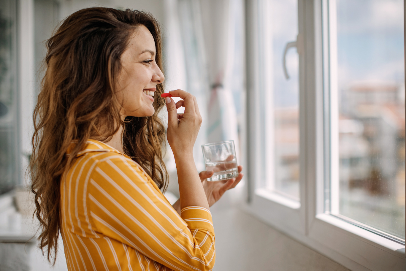 Woman taking her supplements.