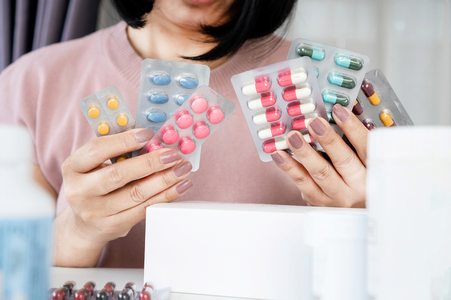 woman holding packs of nsaids