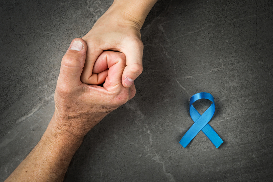 Blue ribbon with supportive hands symbolizing prostate cancer awareness and prevention