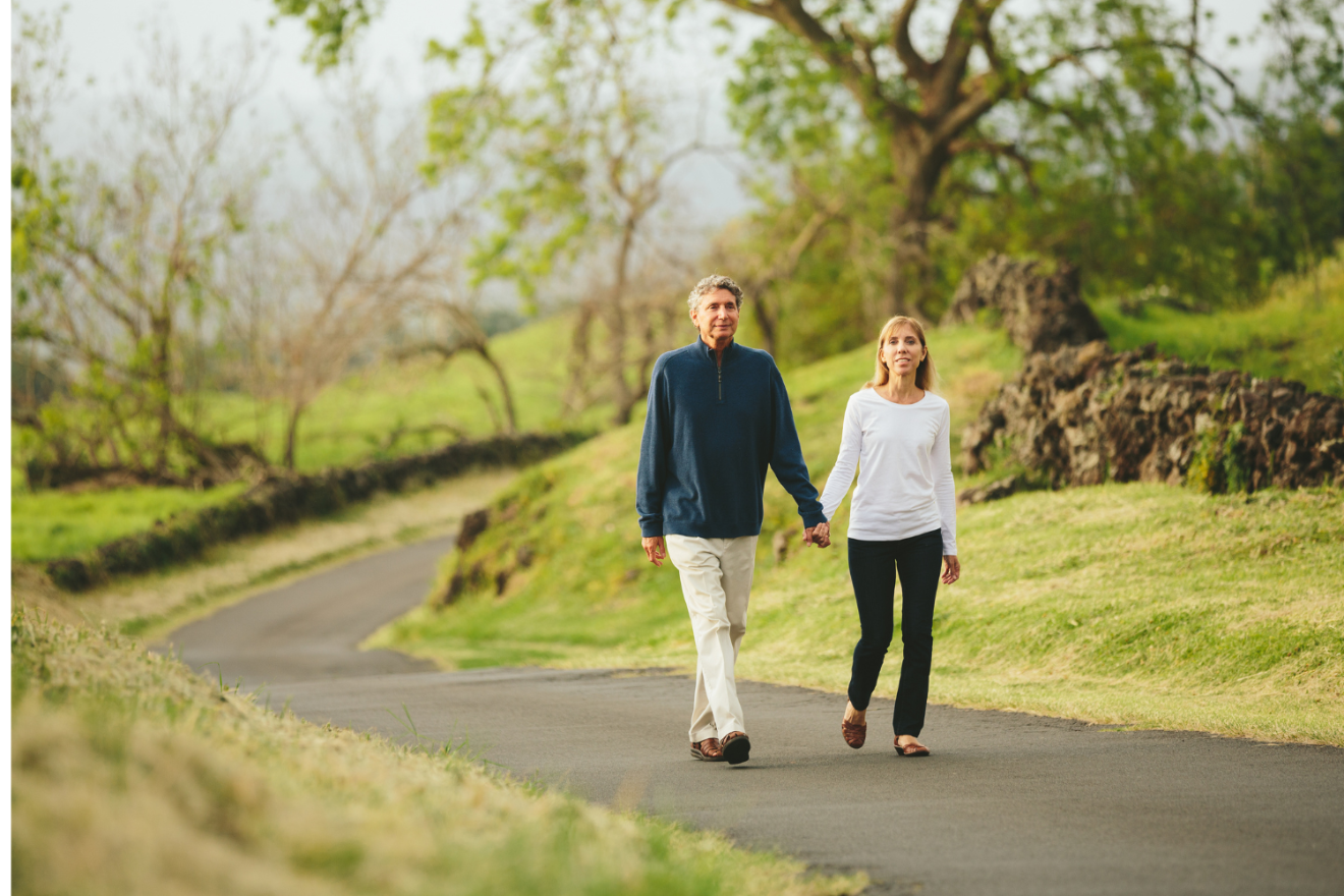 Man and woman walking in a park.