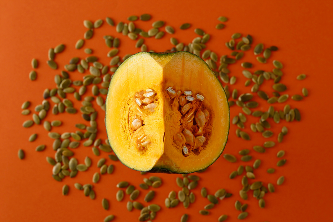Fresh pumpkin cut open showing pumpkin seeds, linked to prostate health.
