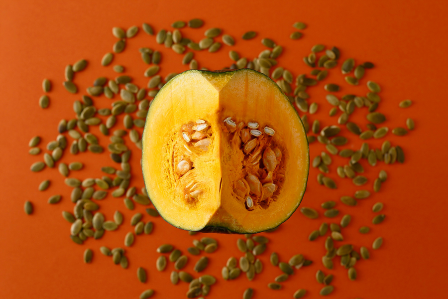 Fresh pumpkin cut open showing pumpkin seeds, linked to prostate health.