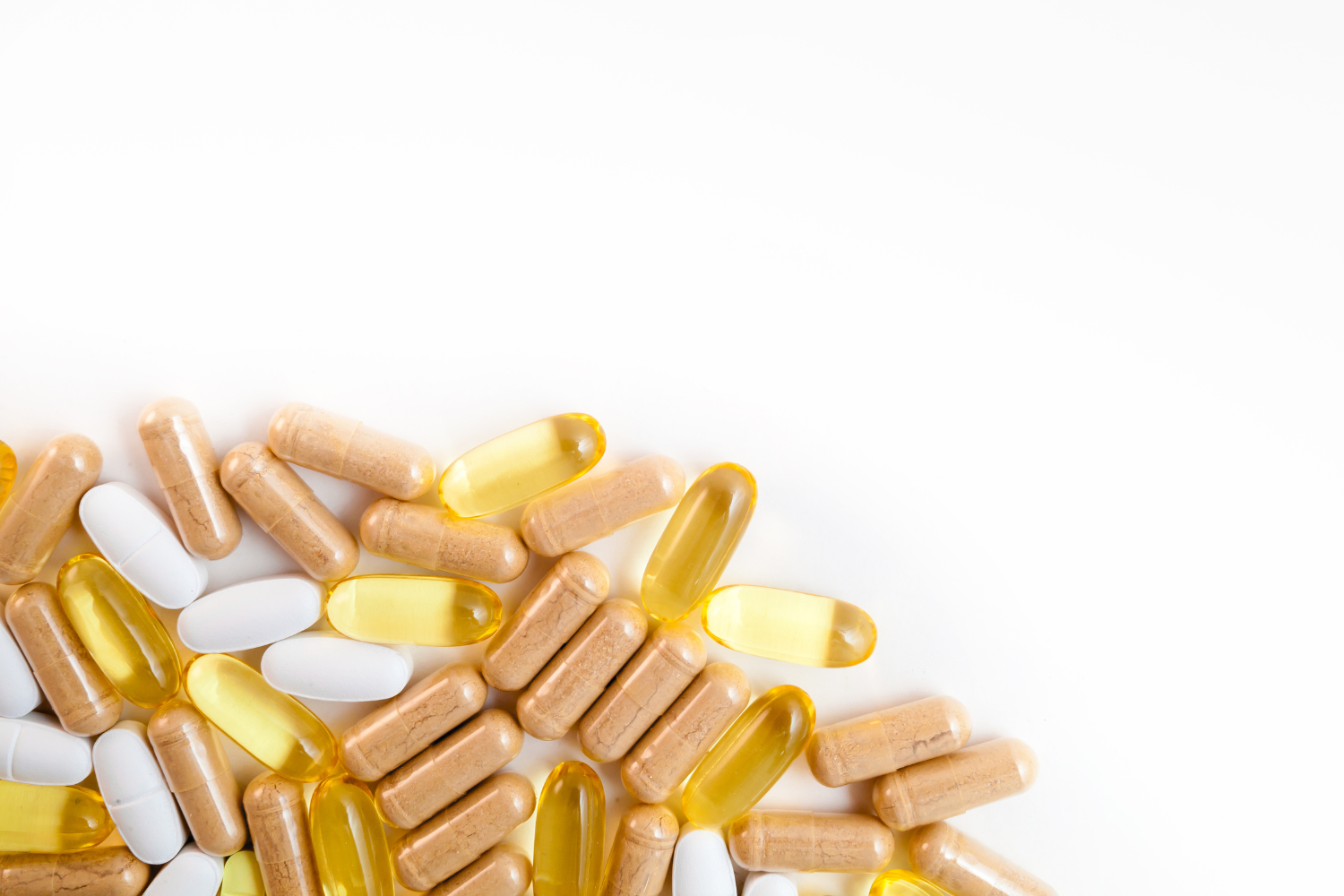 Various types of vitamins on a white surface.