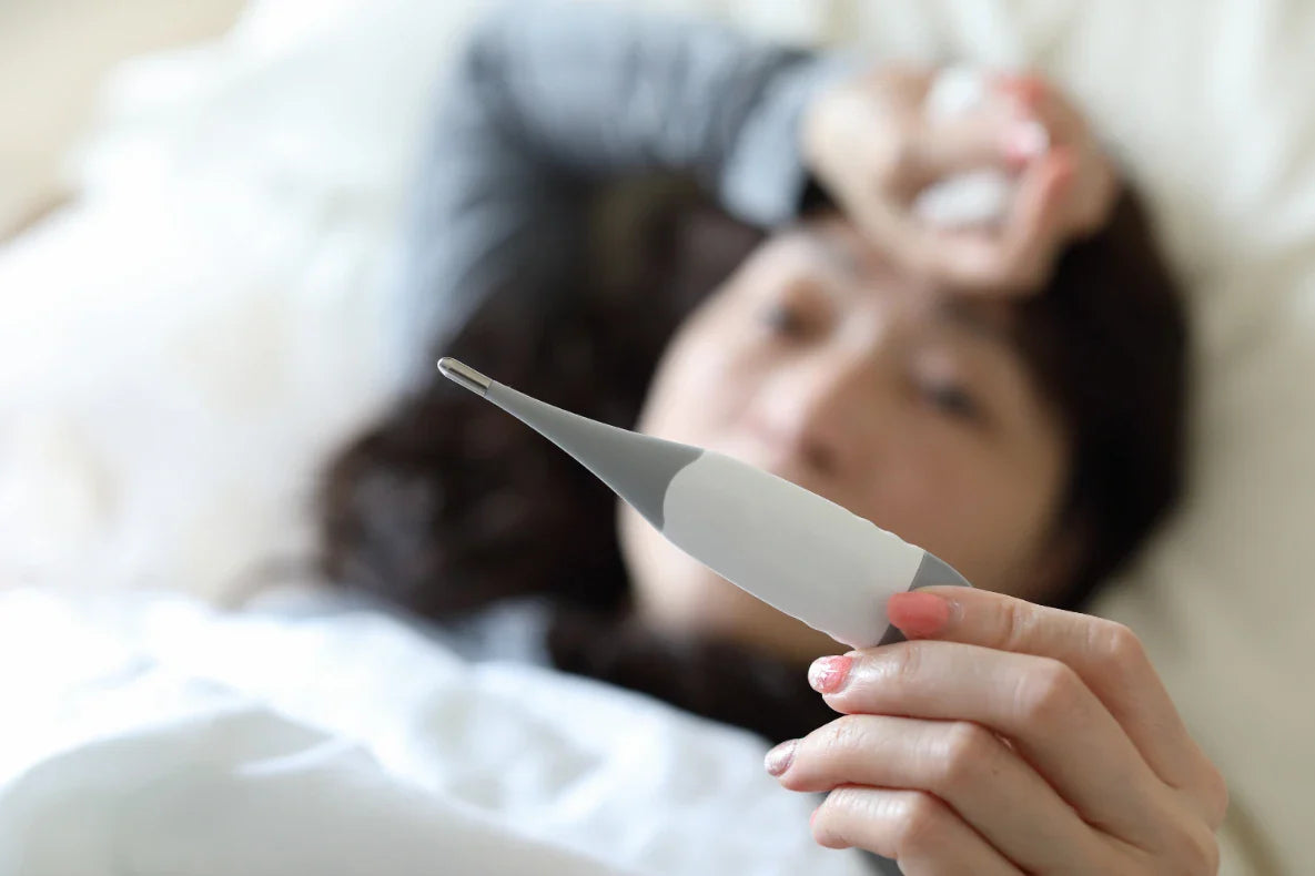A woman checks her temperature.