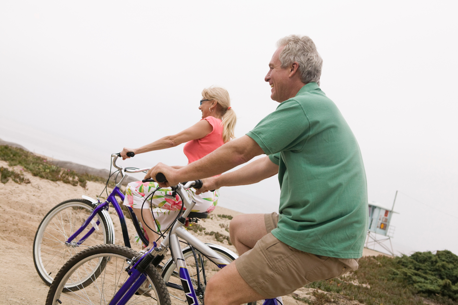 Middle-aged man and wife going on a bike ride.